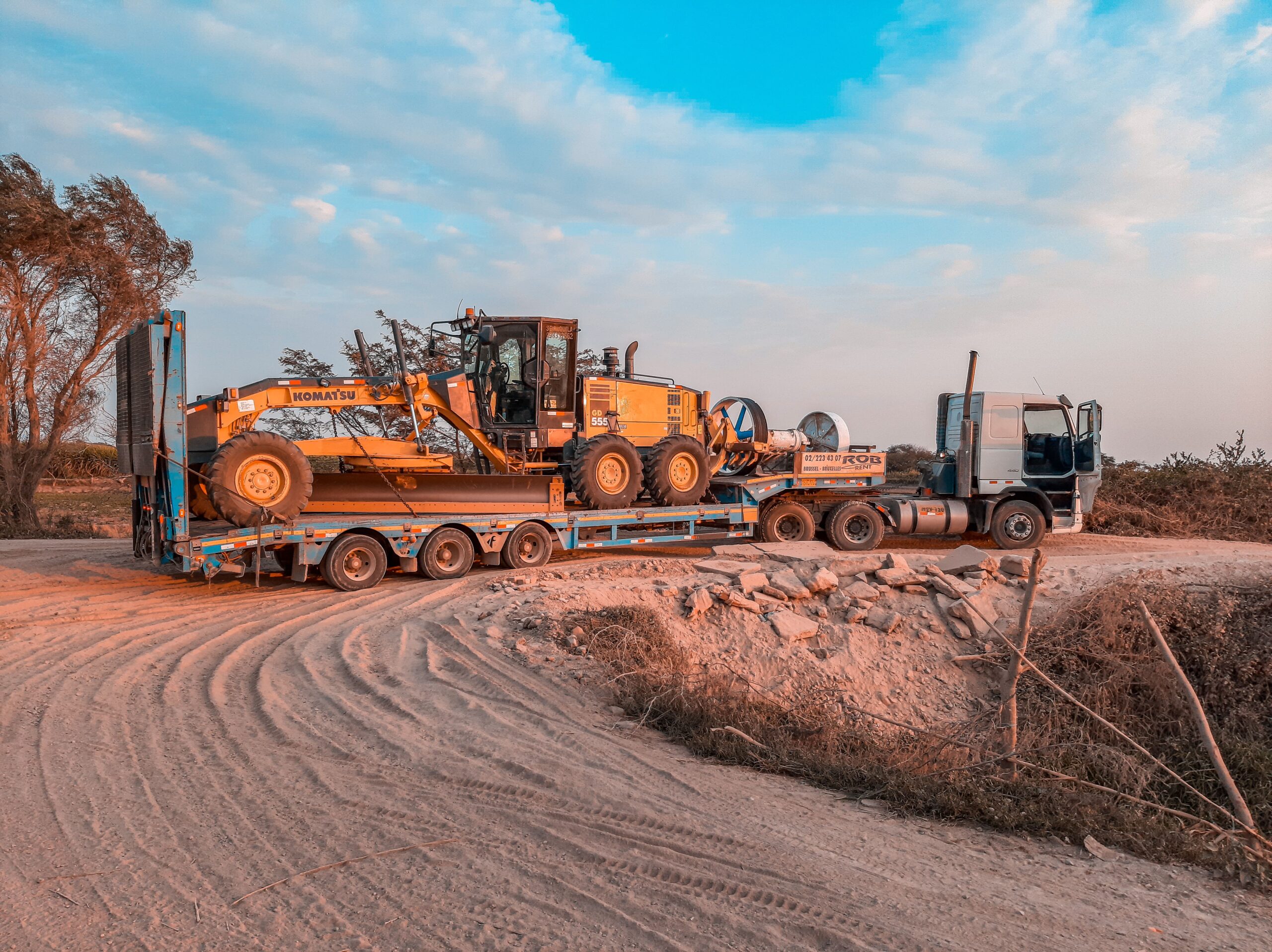 Flatbed trailer carrying heavy equipment freight